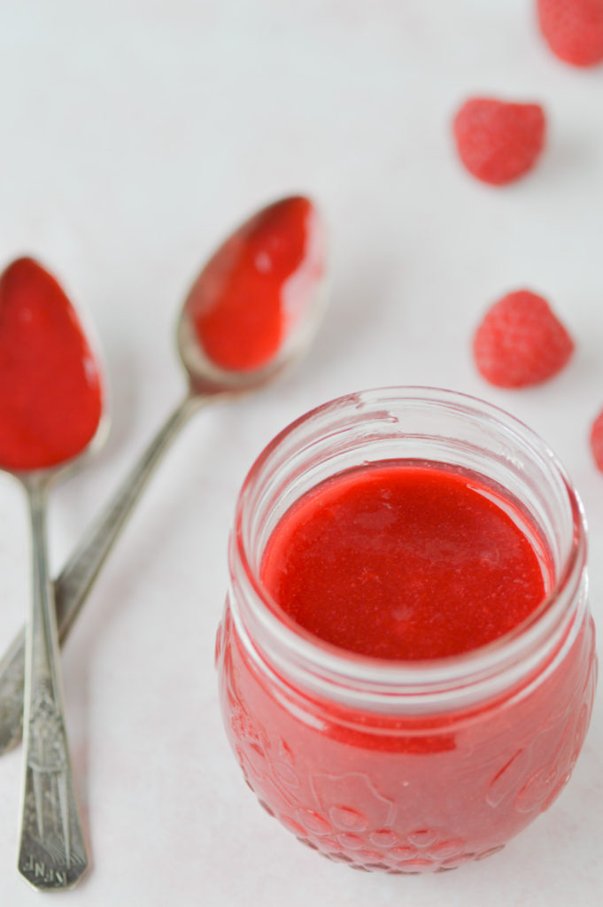 raspberry coulis in jar with spoons