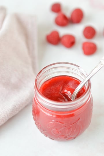 raspberry coulis in jar with spoo