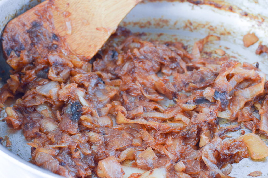 Caramelized Onions in pan with wooden spoon