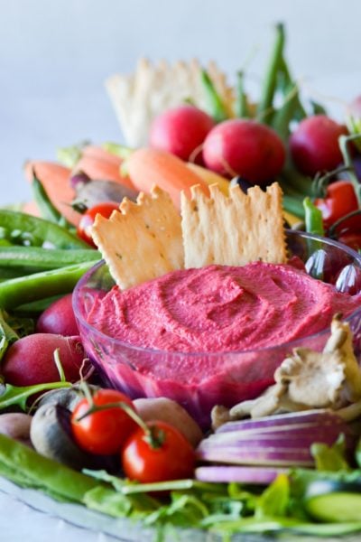 Roasted garlic beet dip with vegetables and crackers