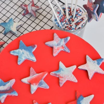 red white blue marble cookies on red cake stand and cooling tracy