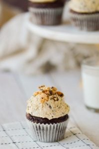 cookie dough on cupcake with cake stand and cupcakes in background