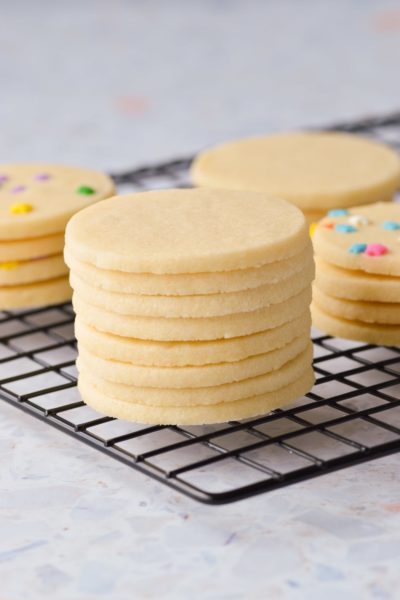 stacked sugar cookies on cooling rack