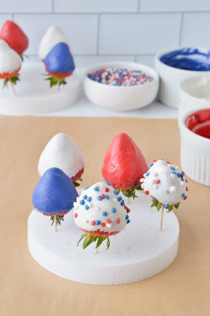 red white and blue chocolate covered strawberries with sprinkles