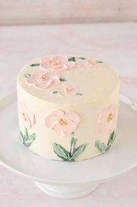pink flowers painted in buttercream on cake