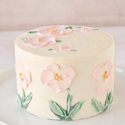 pink flowers painted in buttercream on cake