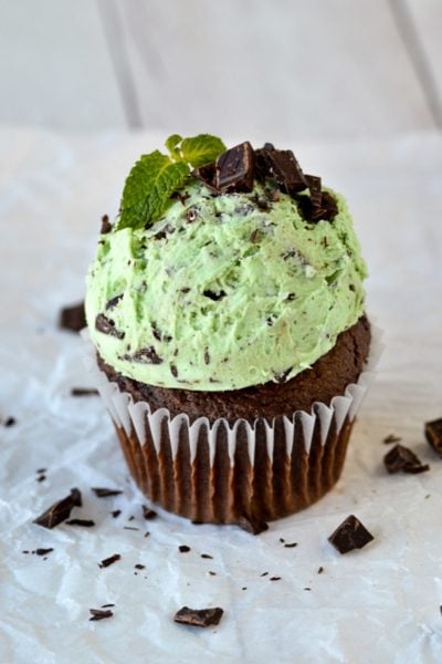 mint frosting on chocolate cupcake topped with chopped chocolate and mint