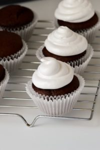 marshmallow frosting piped on cupcakes