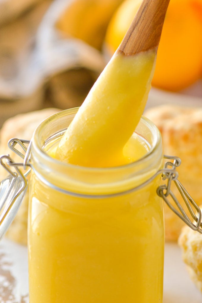lemon curd in jar close up on knife 
