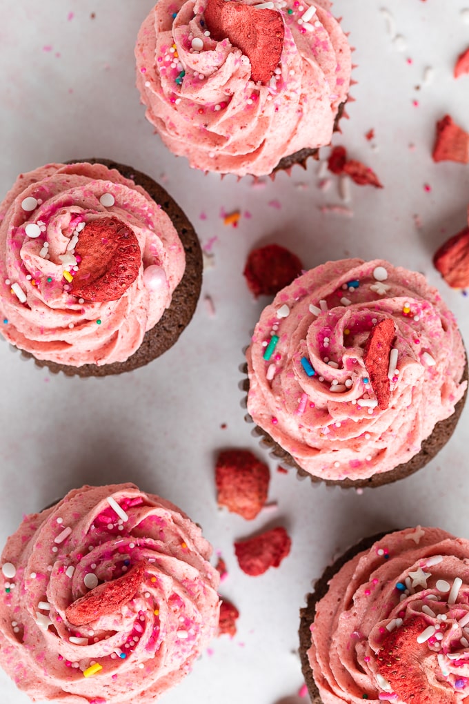 strawberry frosting and sprinkles on cupcakes up close 