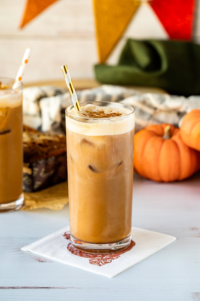 pumpkin cream cold brew in glass with straw