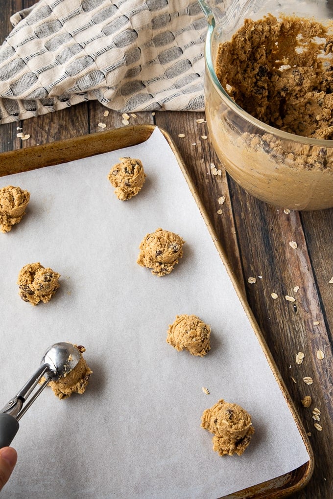 oatmeal cookie dough on parchment baking sheet