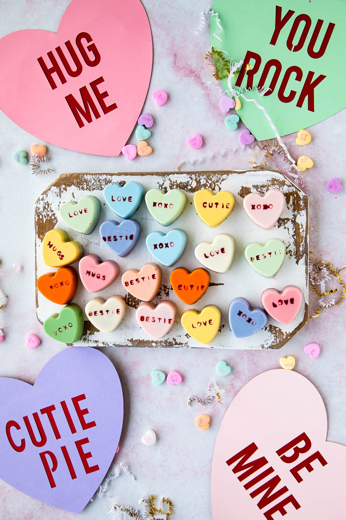 heart cake bites with paper hearts and sweetheart conversation hearts 