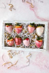 pink and white valentine's day chocolate covered strawberries in box.