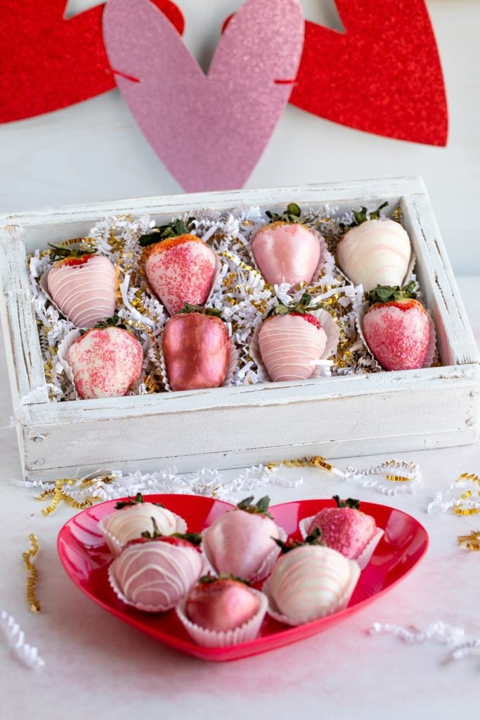 pink chocolate covered strawberries on heart plate and in box