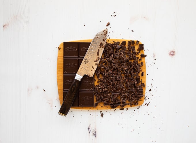 chopped chocolate bar on cutting board with knife