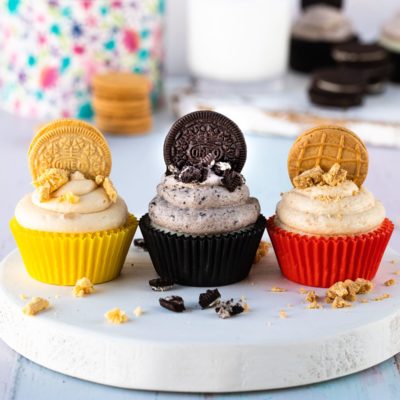 three types of cookies and cream frosting on cupcakes