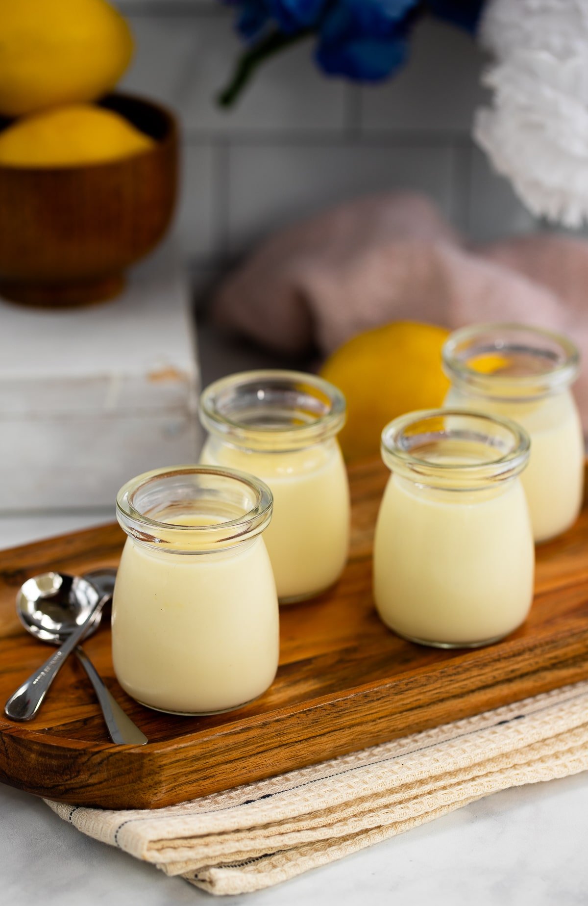 lemon posset in glass containers on serving tray.