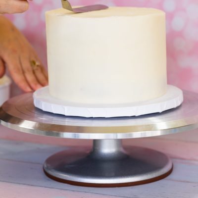 frosting a cake on a turntable