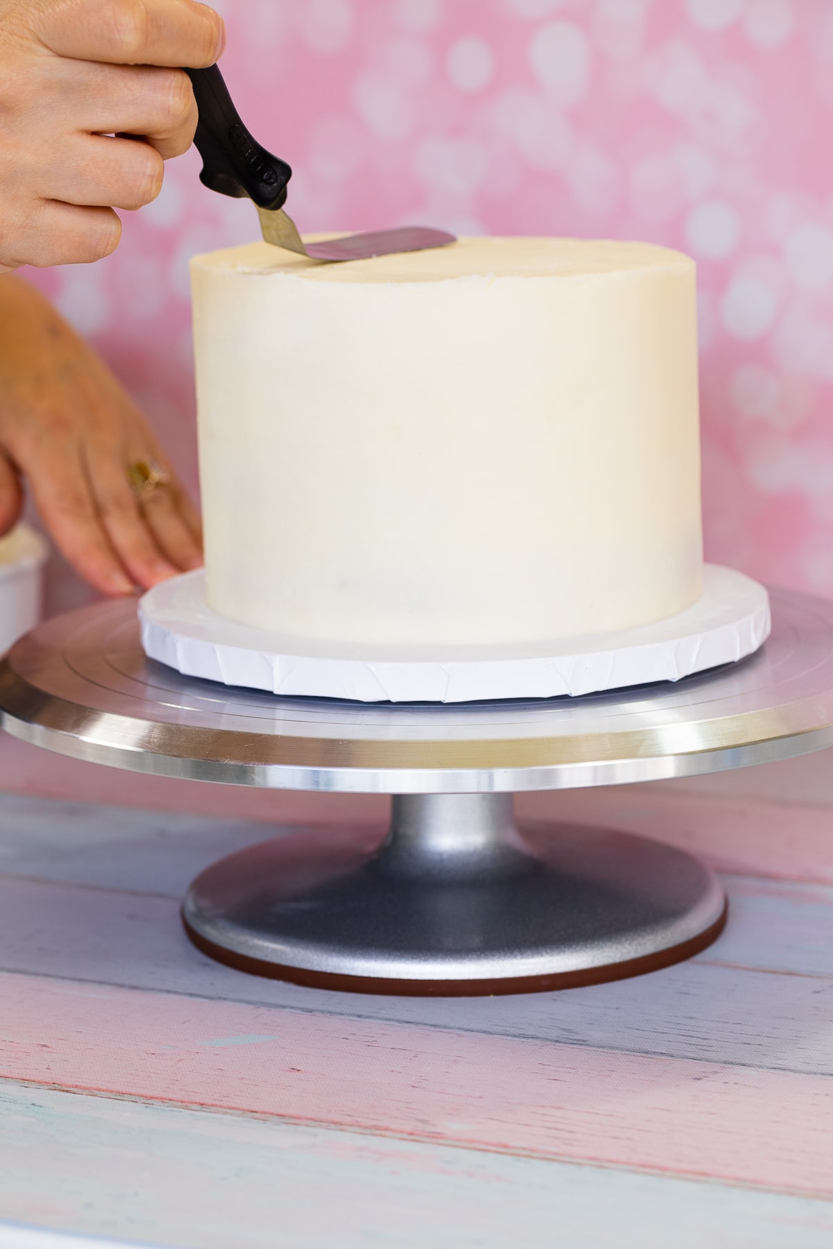frosting a cake on a turntable 