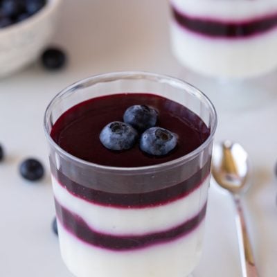 blueberry coulis on panna cotta cup close