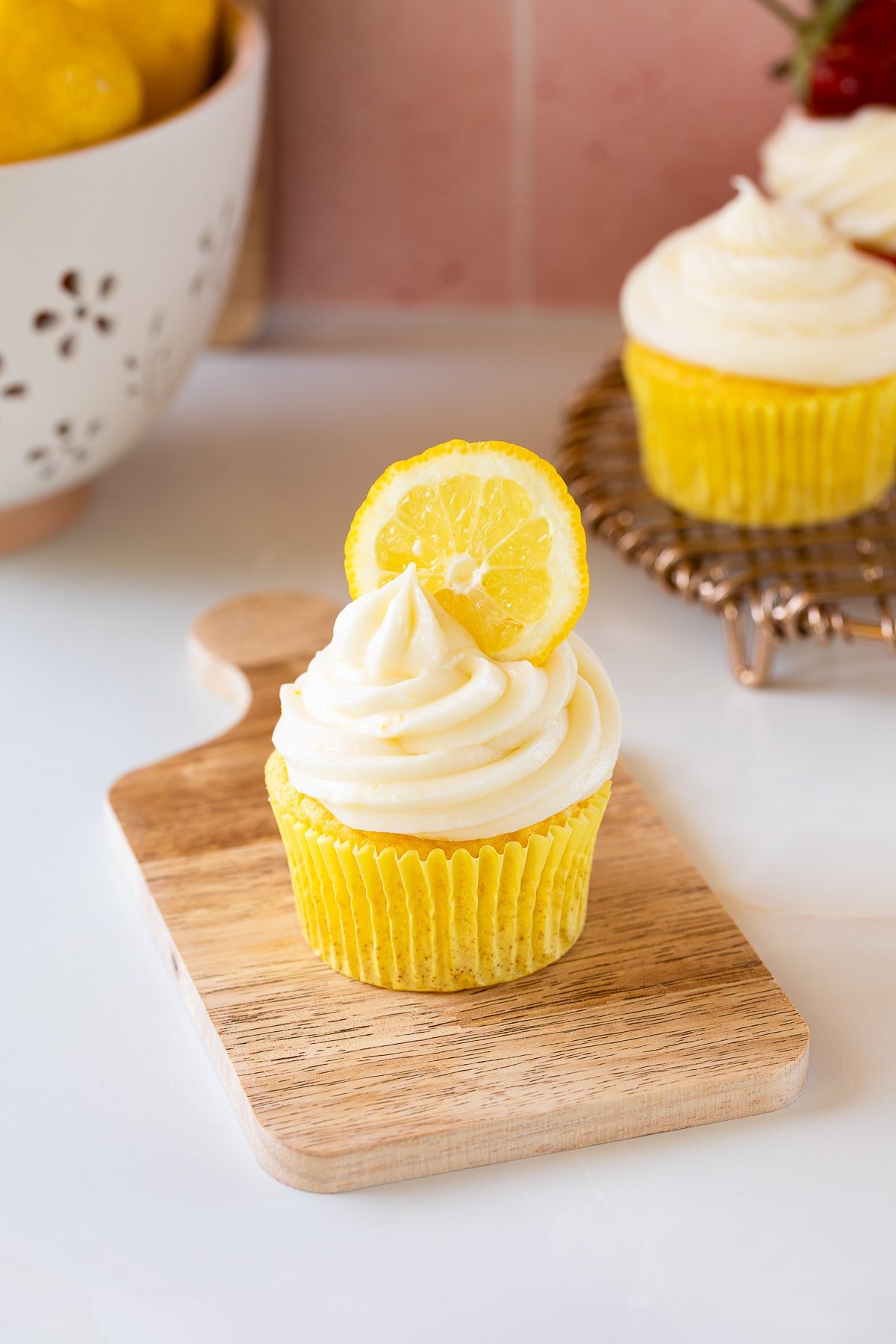 lemon cream cheese frosting on cupcake with lemon slice