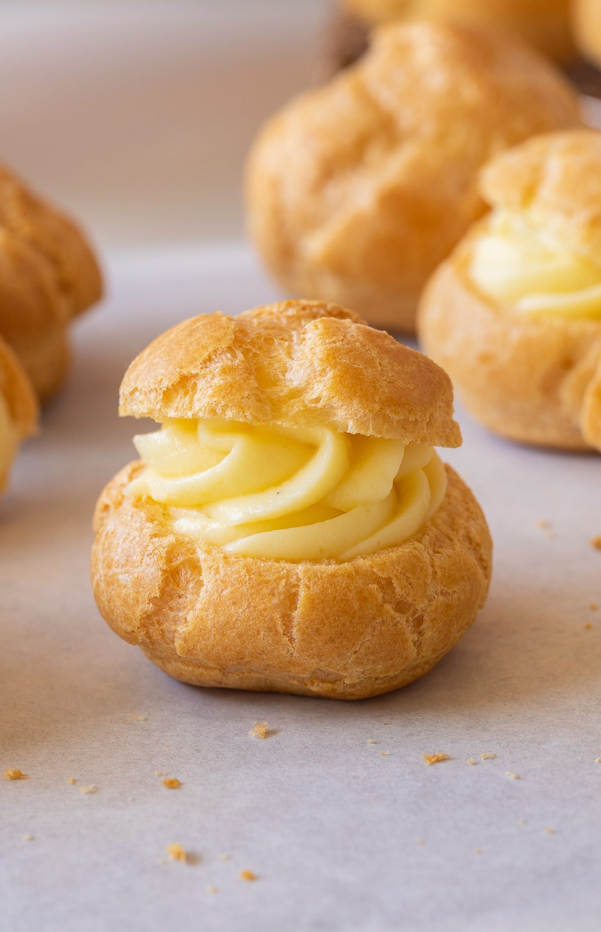 cream puff filled with pastry cream up close.