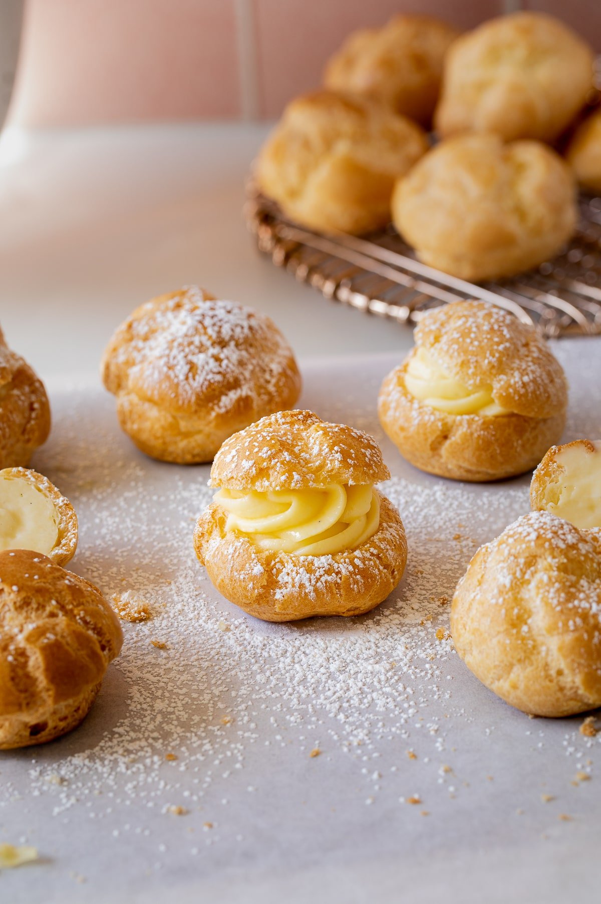 cream puff filled with pastry cream and topped with powdered sugar.