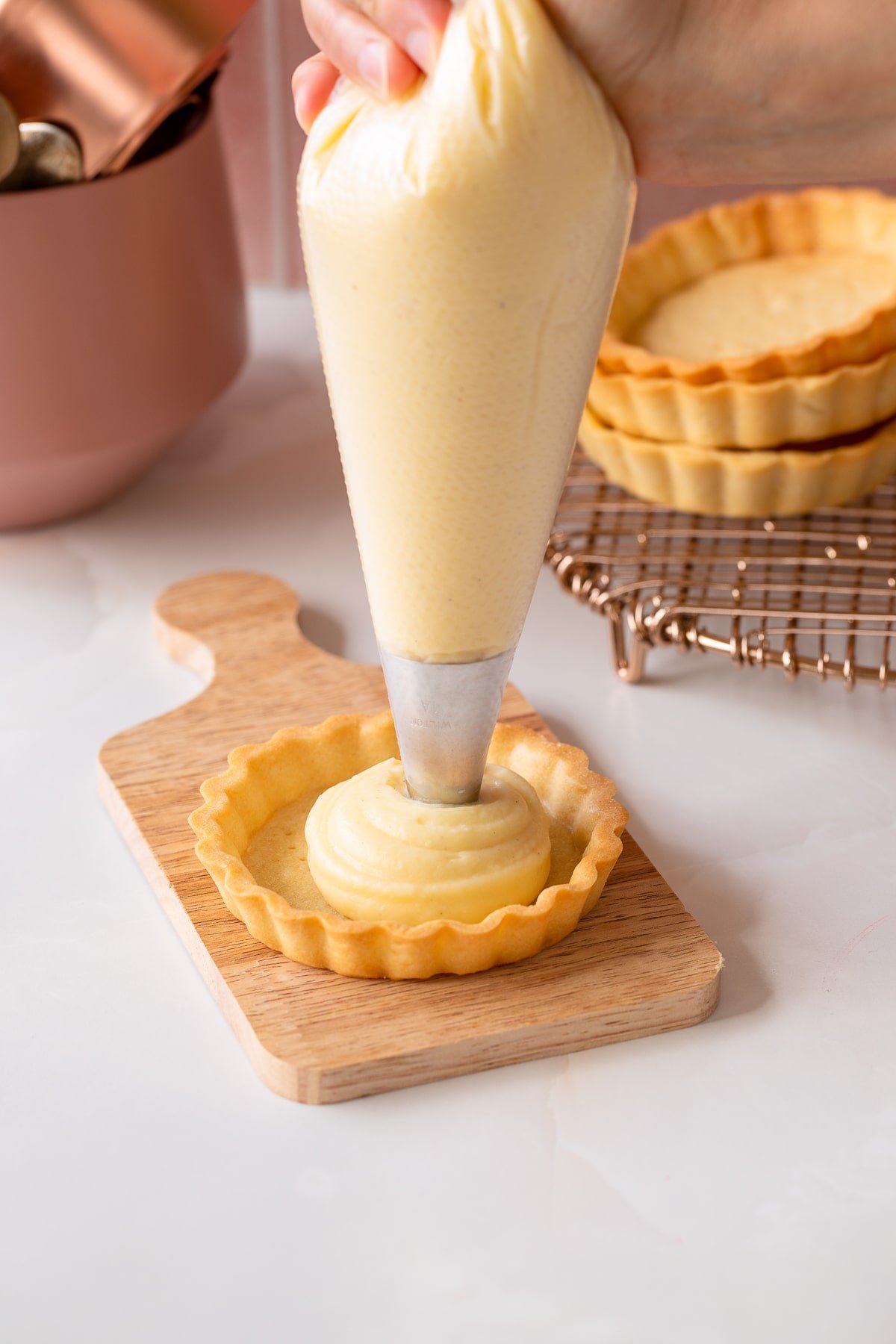 piping pastry cream into tart