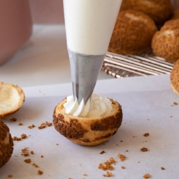 piping stabilized whipped cream into cream puff