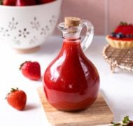 strawberry coulis in glass bottle