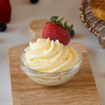 diplomat cream piped in bowl with strawberry up close.
