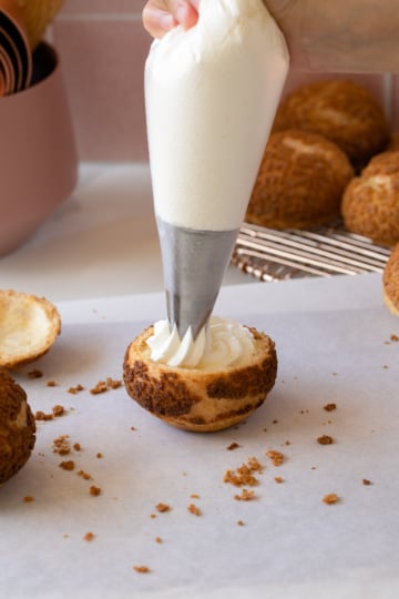 stabilized whipped cream in bowl and being piped into cream puff.