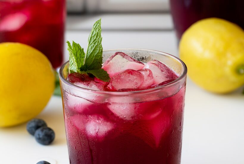blueberry lemonade is glass with mint.