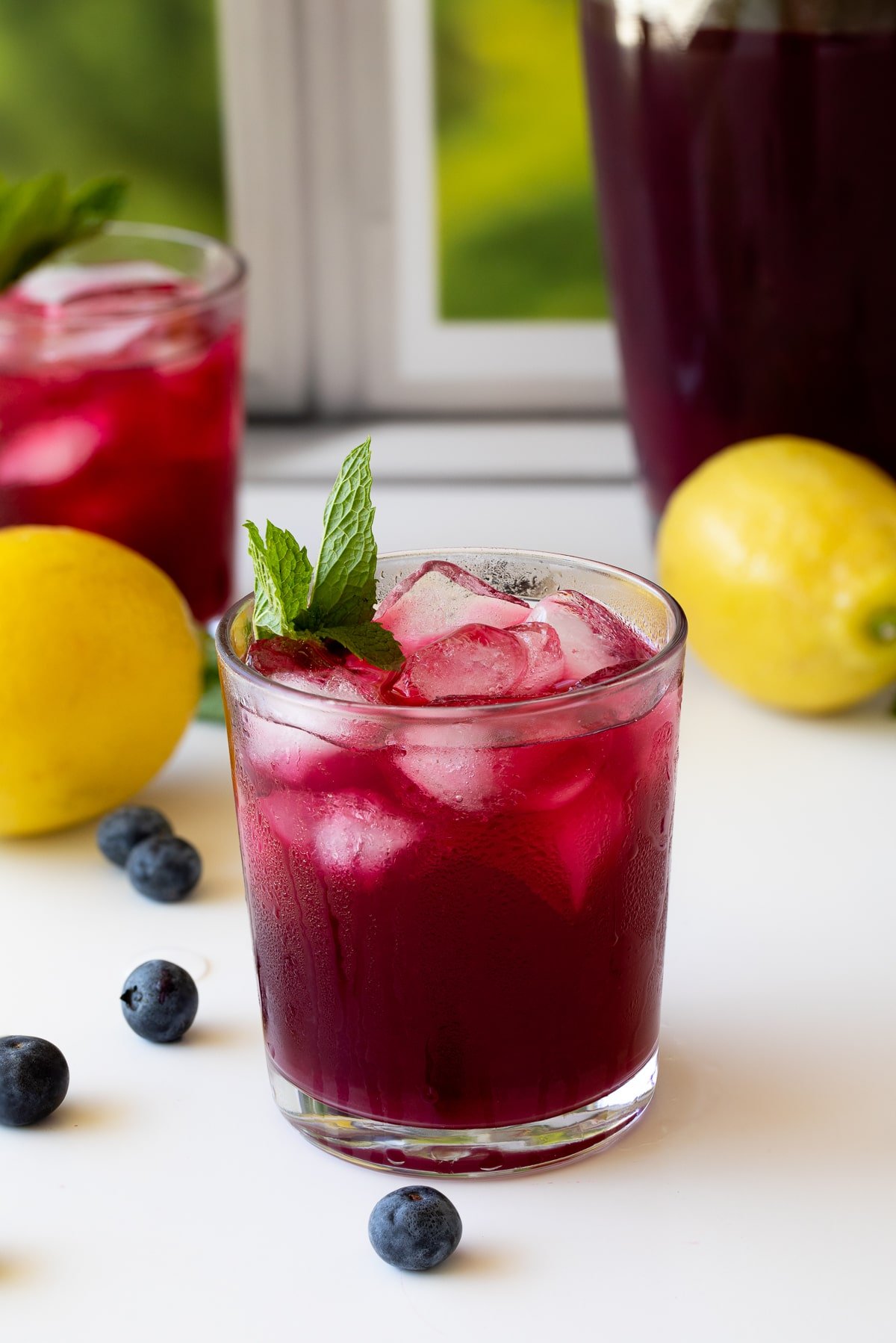blueberry lemonade is glass with mint.