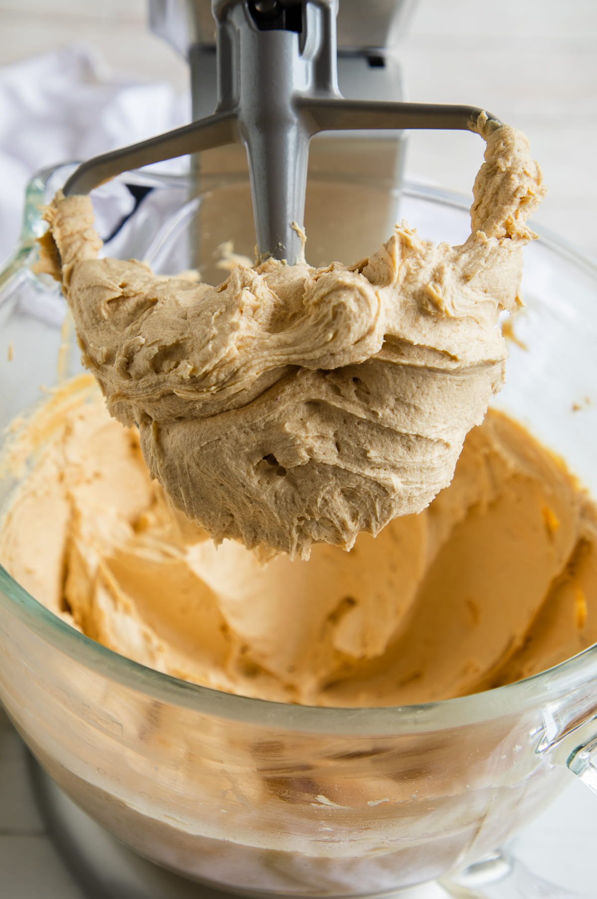 peanut butter frosting on beater up close.
