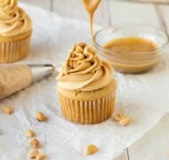 peanut butter frosting on cupcake dripping melted peanut butter with spoon.
