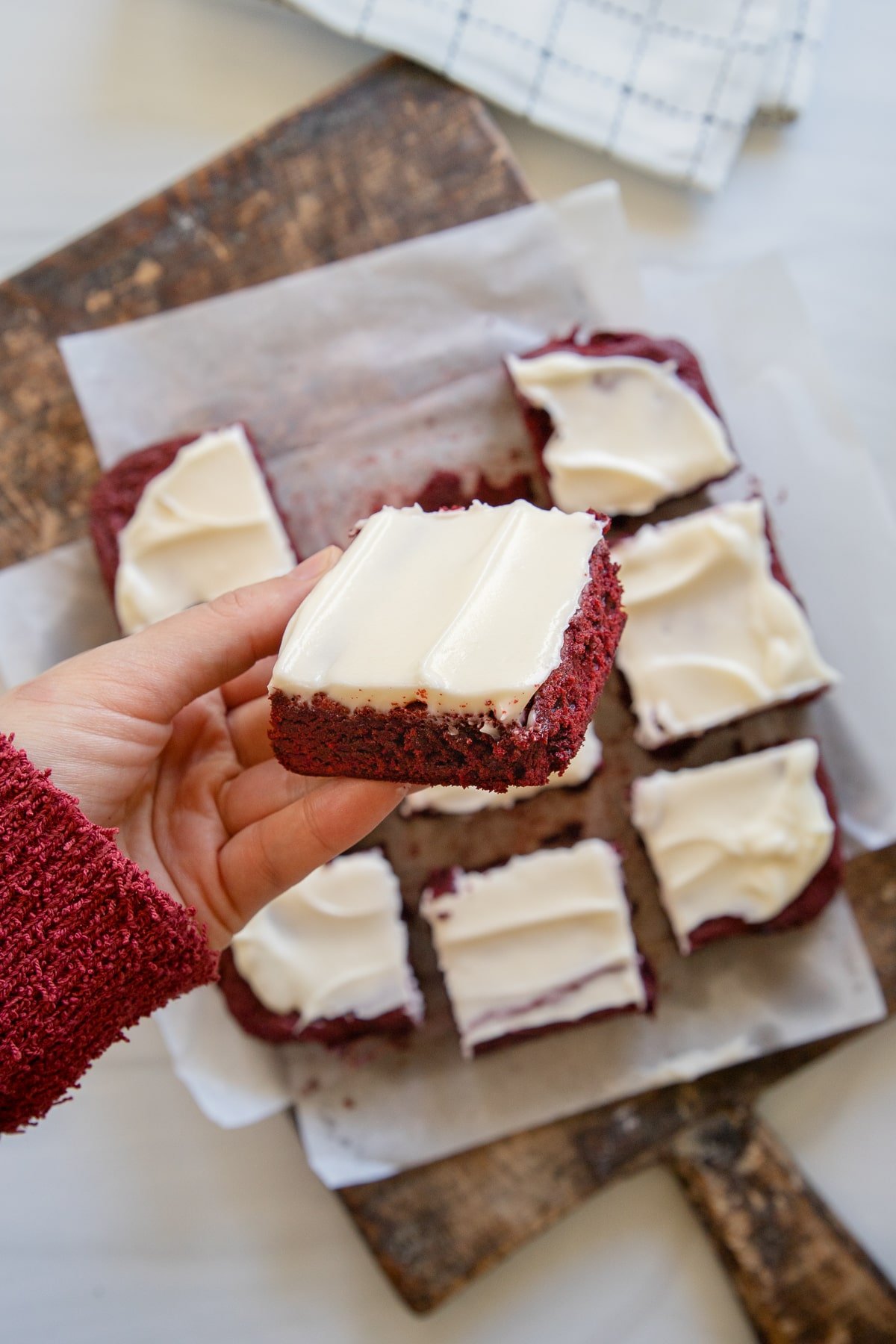 holding a red velvet brownie up close 