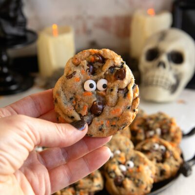 holding a halloween chocolate chip cookies.