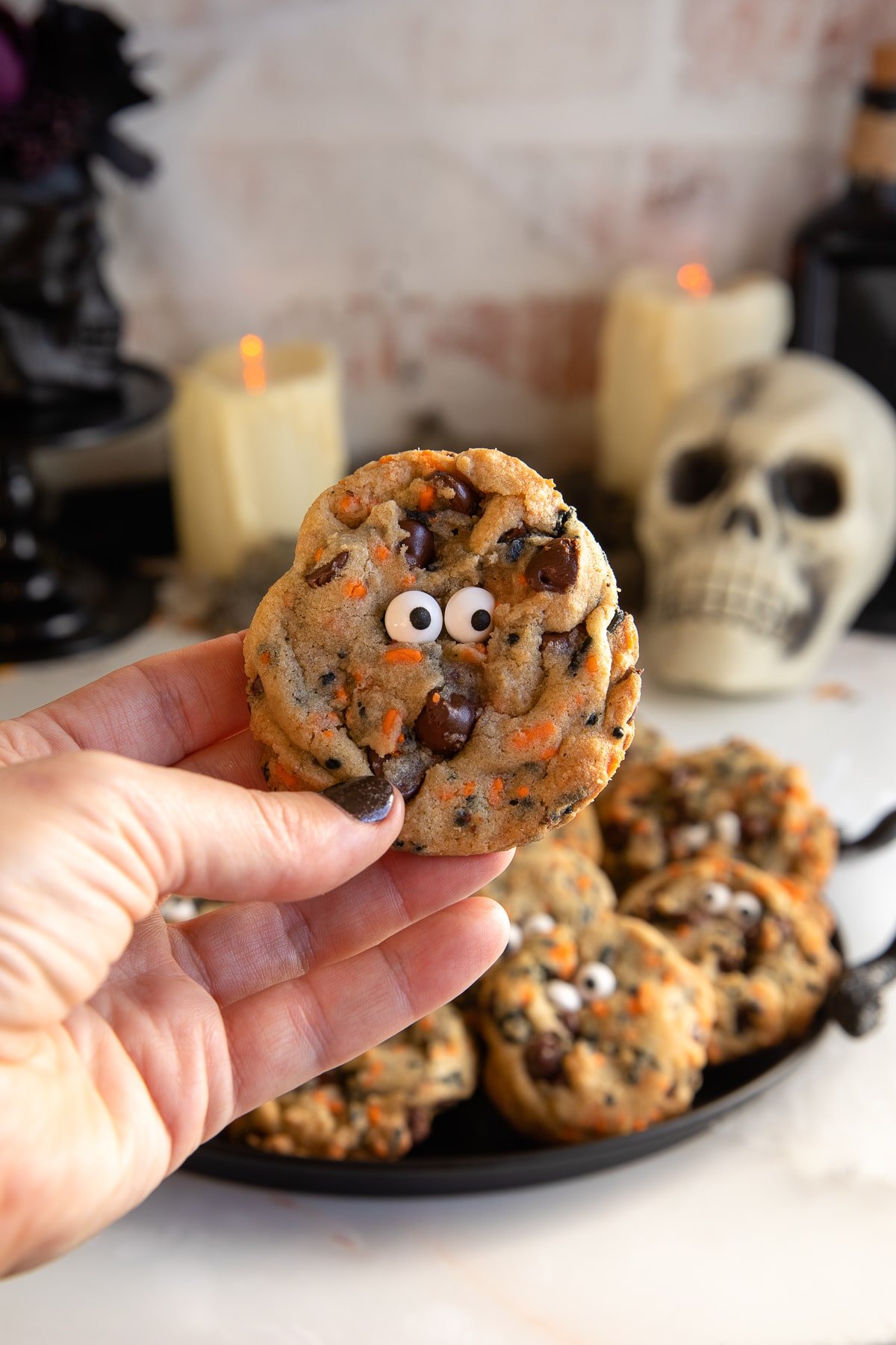 holding a halloween chocolate chip cookies.