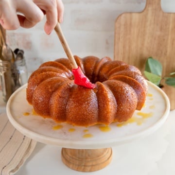 brushing an Italian hangover cake with glaze.
