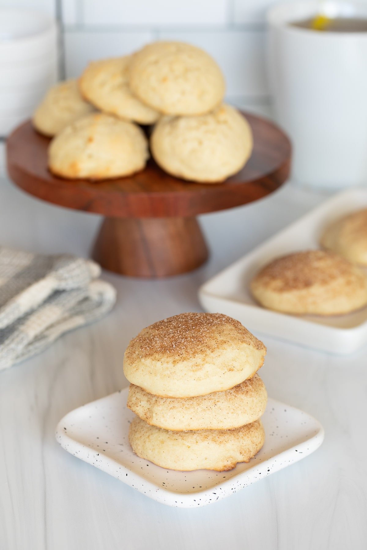 sour cream cookies stacked on small plate.