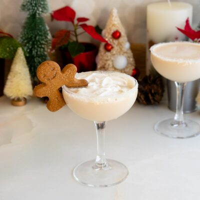 sugar cookie martini in glass with whipped cream and cookie.