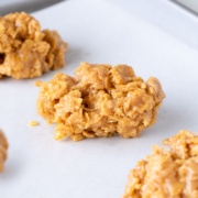 peanut butter cornflake cookies on parchment up close.