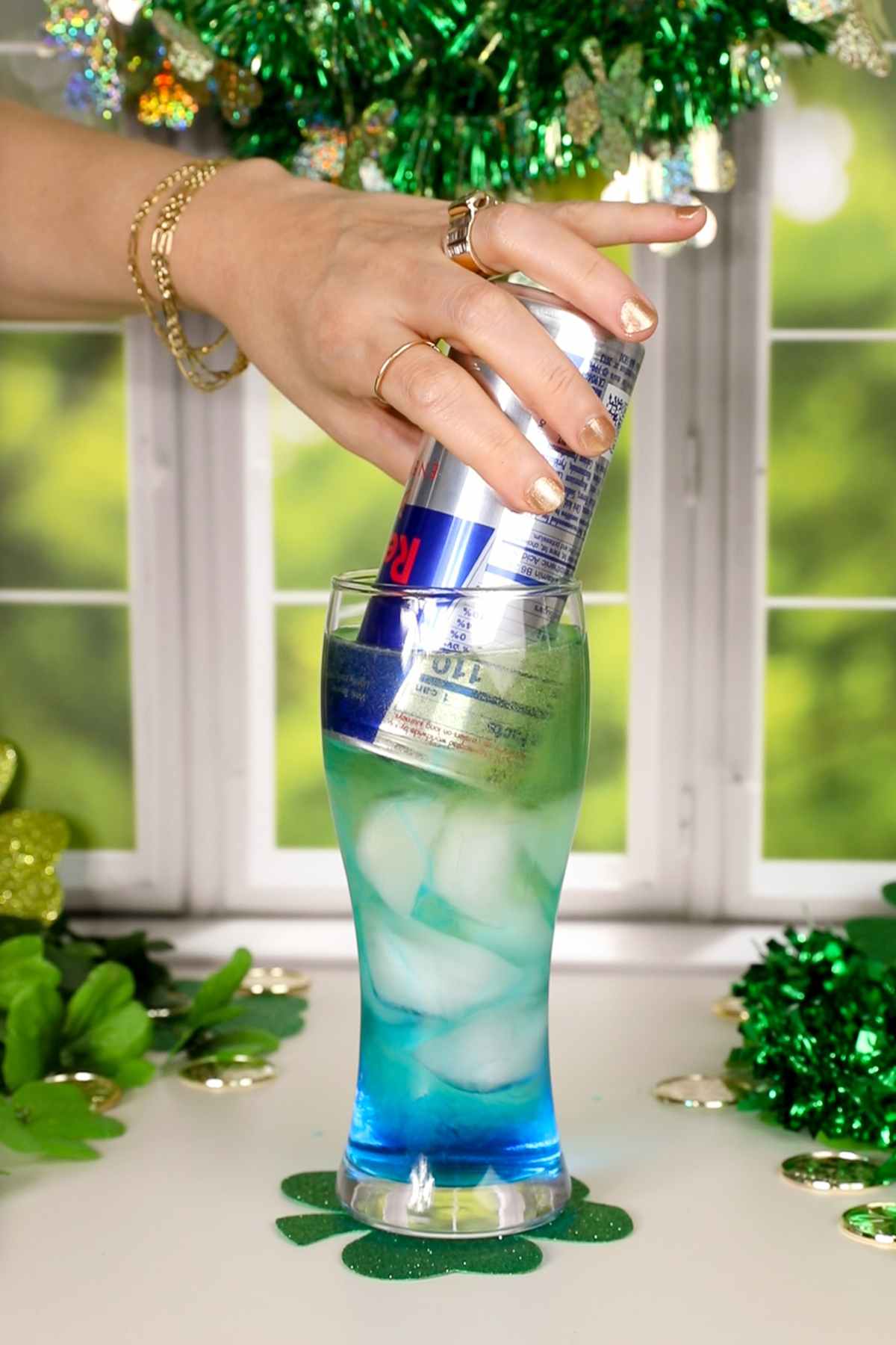 pouring red bull onto irish trash can drink.