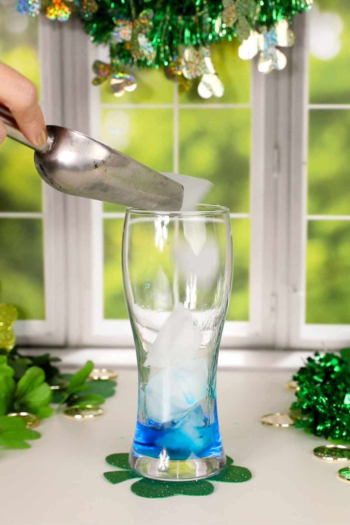 adding ice to a glass for an irish trash can.
