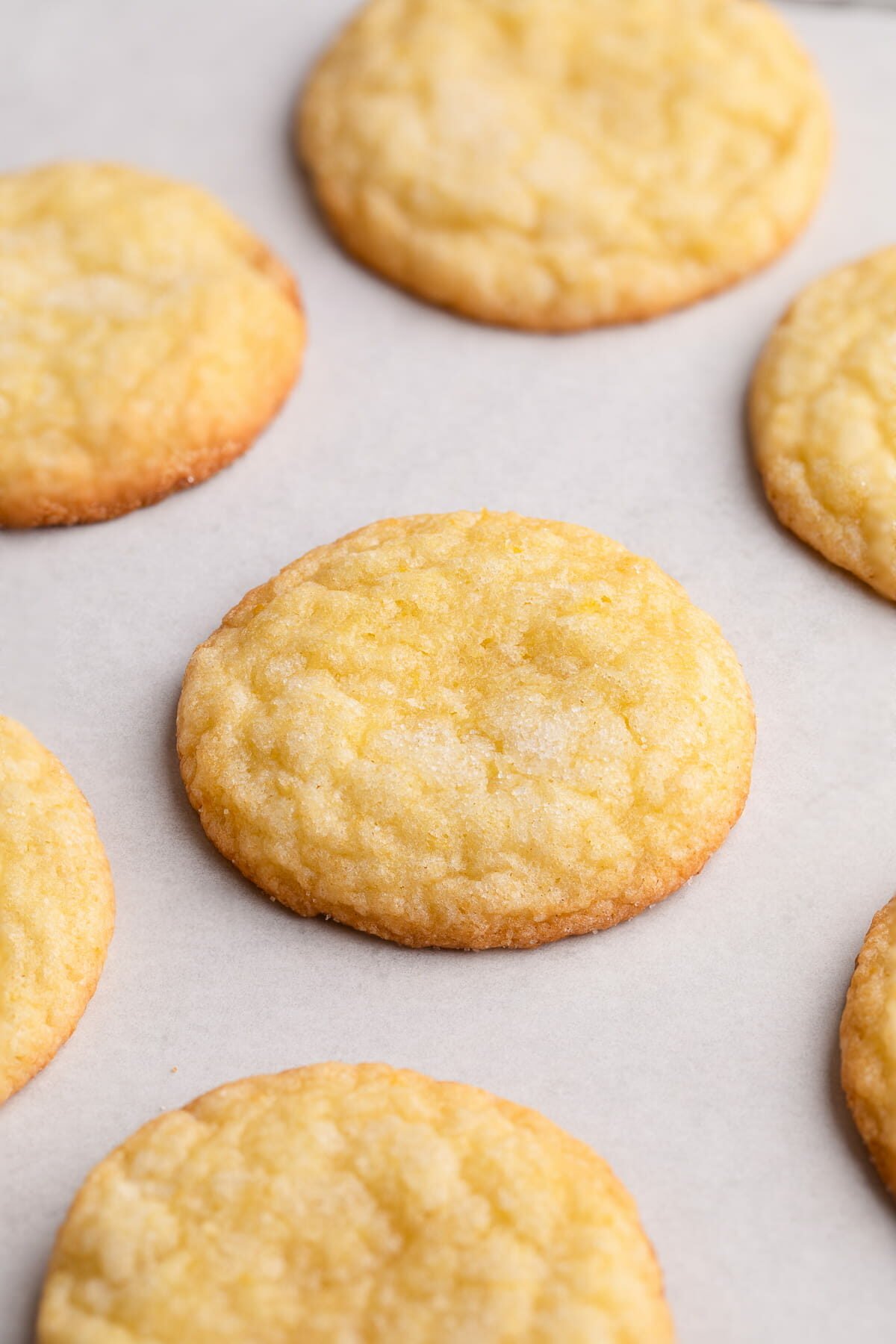 baked soft lemon cookies on baking sheet.