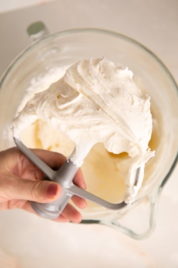 holding a beater of champagne buttercream.
