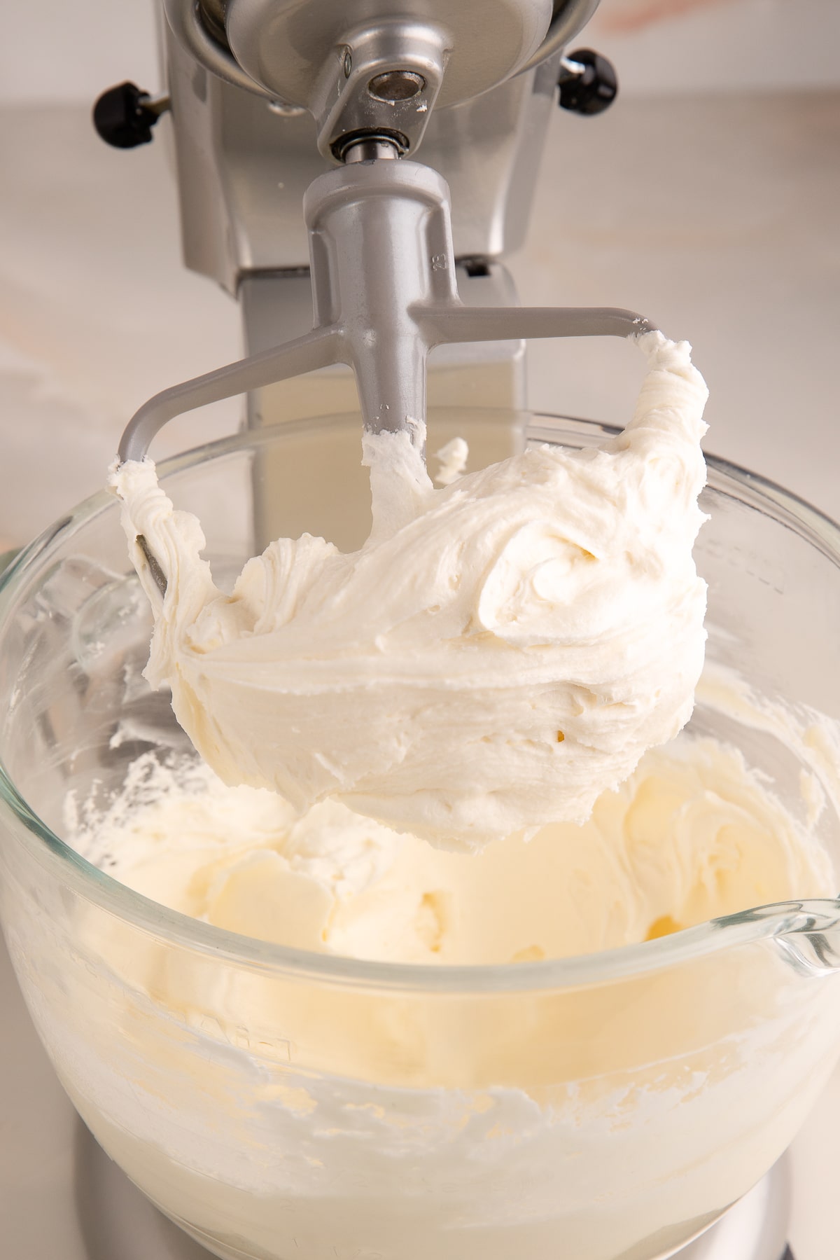 champagne frosting on beater in bowl.