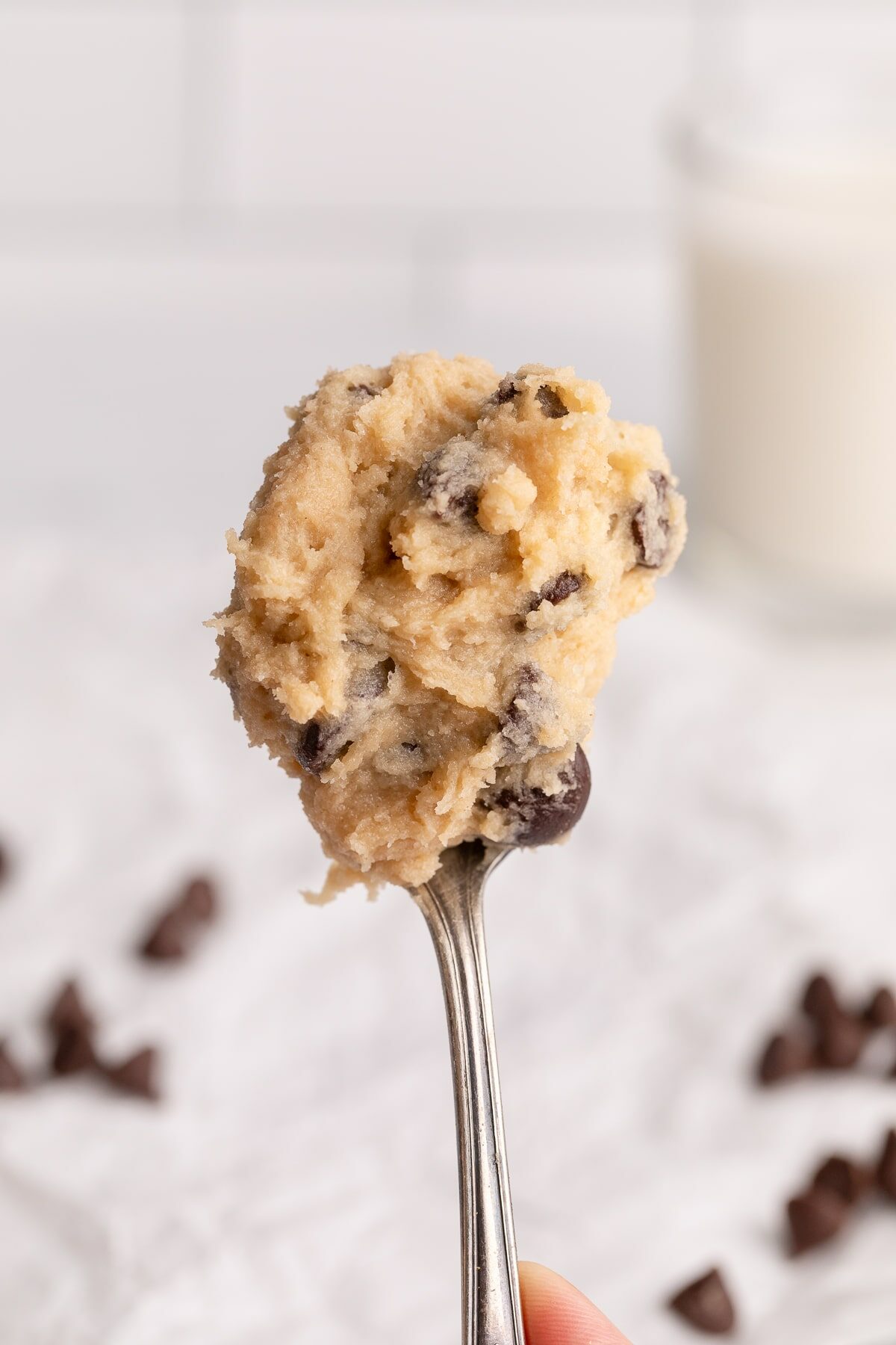 edible chocolate chip cookie dough on spoon.